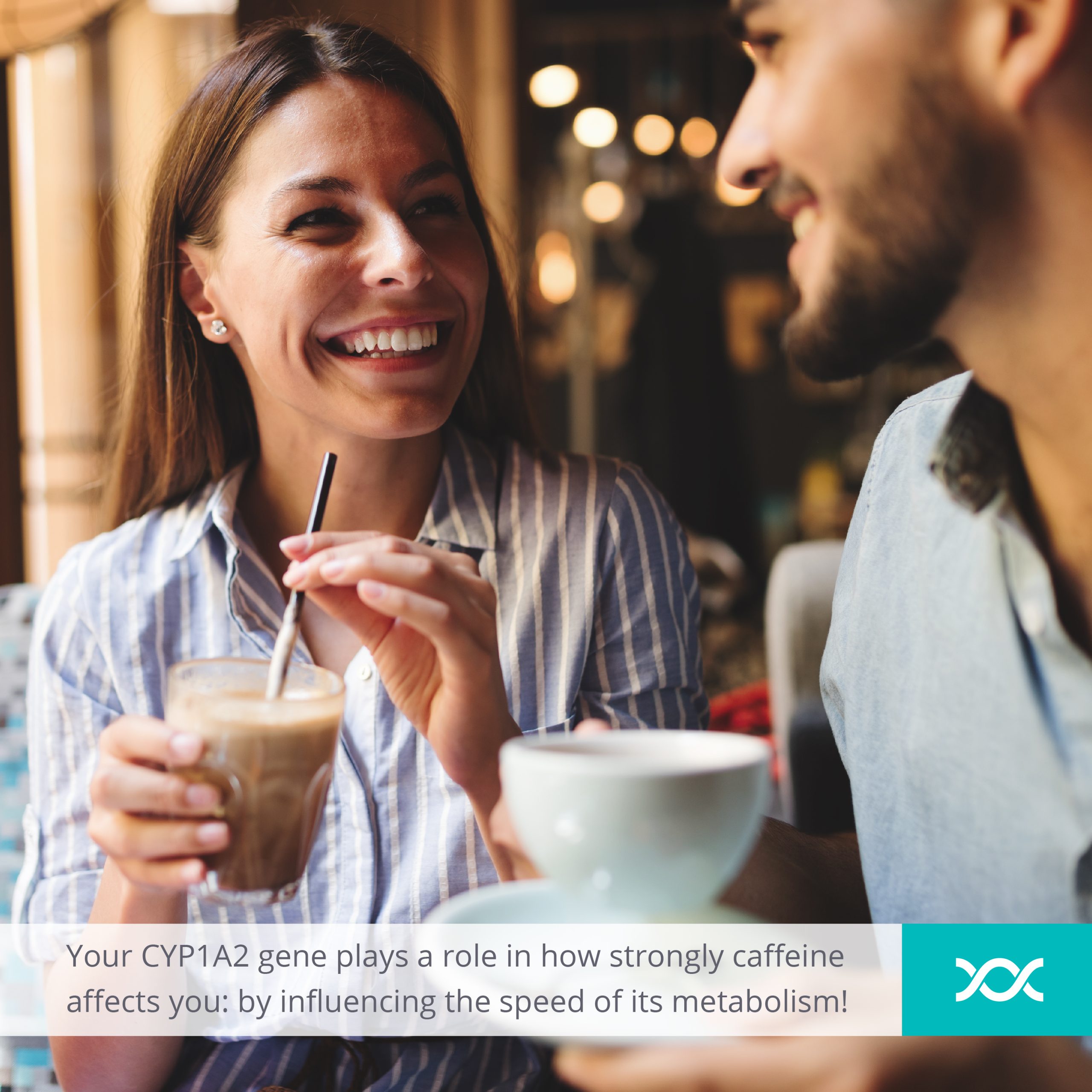 A man and a woman laughing while drinking coffee in a coffee bar