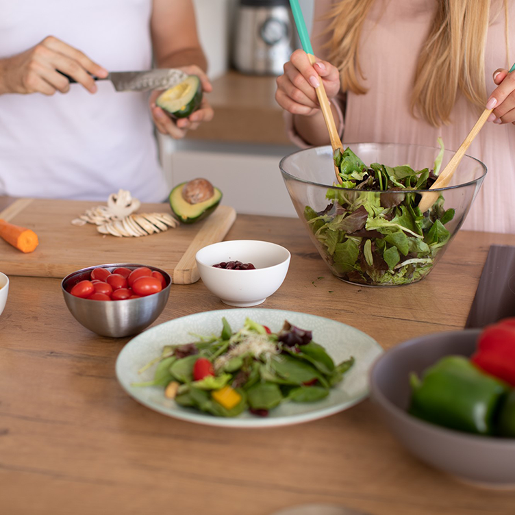 A couple preparing a salad in the kitchen