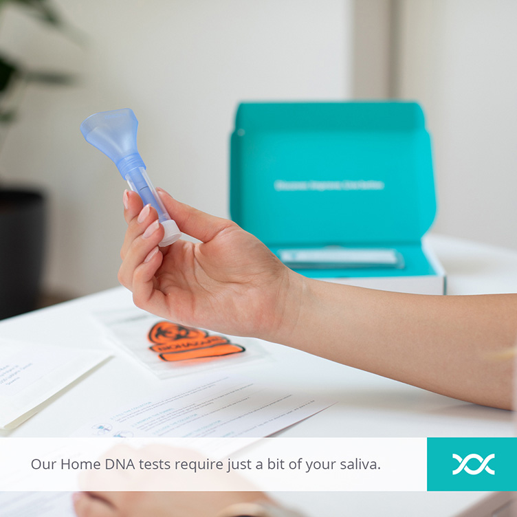 Woman holding the saliva collector from the Home DNA test and reading the instructions