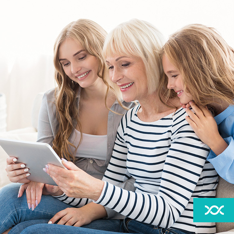 Three generations of women looking at the screen with DNA results