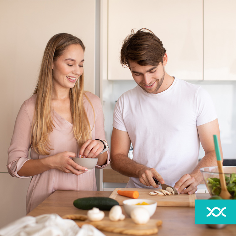 Young couple preparing a meal together in the kitchen