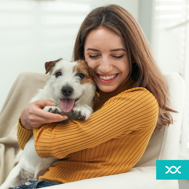 A lady hugging her dog