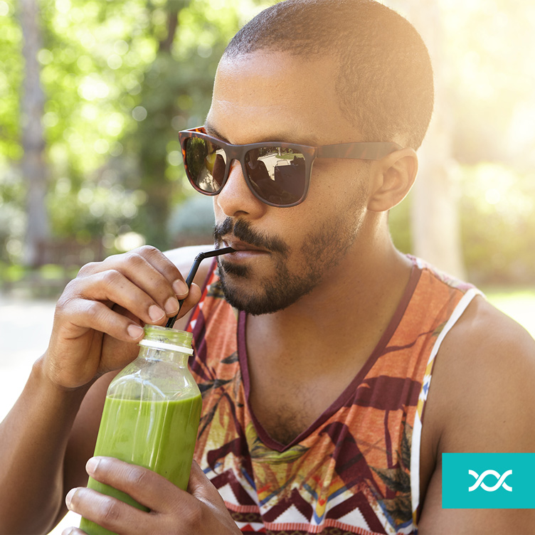 Young man drinking green juice