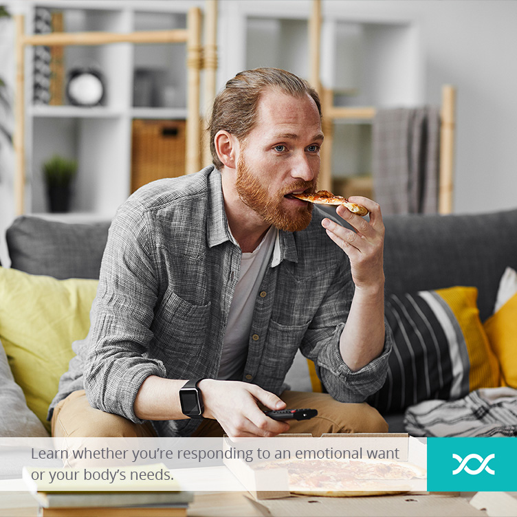 A man eating pizza while watching tv at home